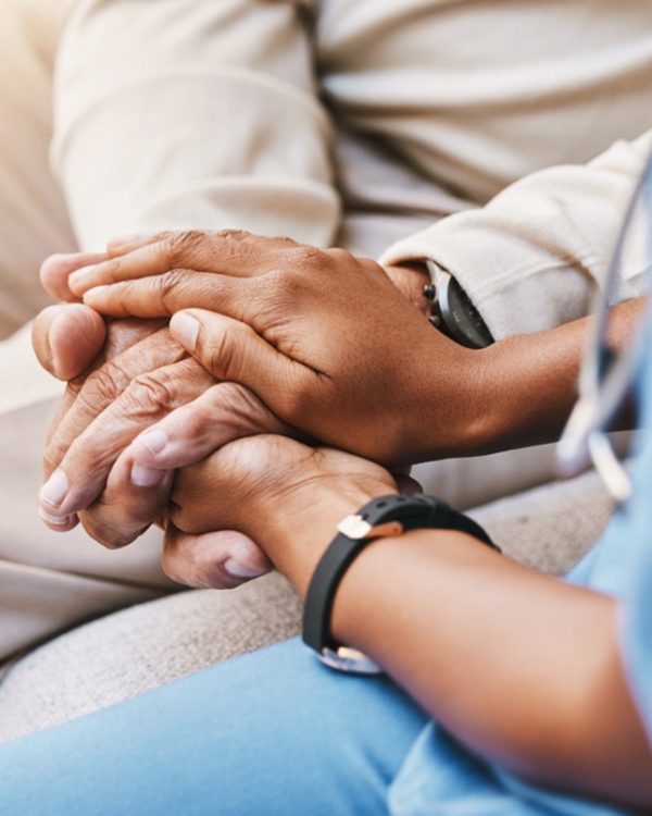 Nurse holding hands with patient in empathy, trust and support of help, advice and healthcare consulting. Kindness, counseling and medical therapy with doctor for hope, consultation and depression